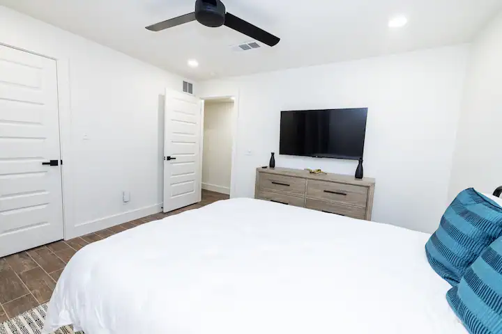 Sandy Shores Oasis bedroom with television and fan for comfort