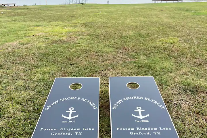 Sandy Shores Oasis cornhole boards to play by the lake