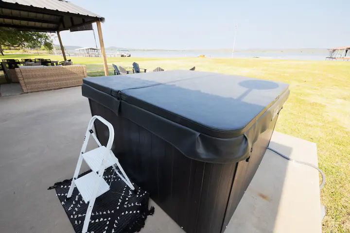 Sandy Shores Oasis outdoor hot tub by the lake