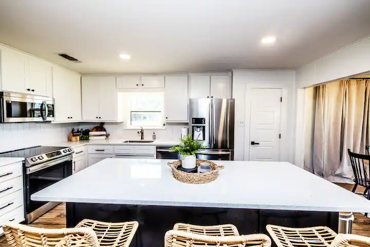 Sandy Shores Oasis bright kitchen with large island and bar stools